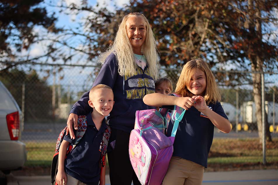 student in classroom smiling at camera