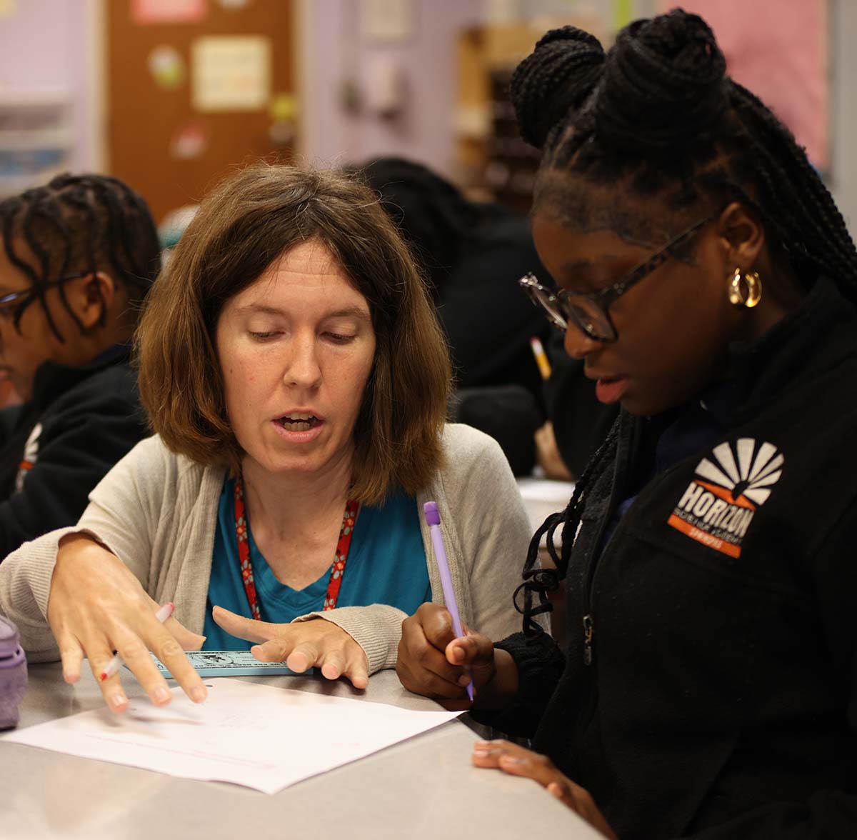 Horizon Science Academy Springfield Teacher and student interacting at a classroom desk